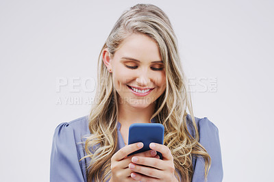 Buy stock photo Smartphone, typing and woman in studio with smile for social media, internet and online chat. Communication, white background and happy female person on cellphone for website, mobile app and texting