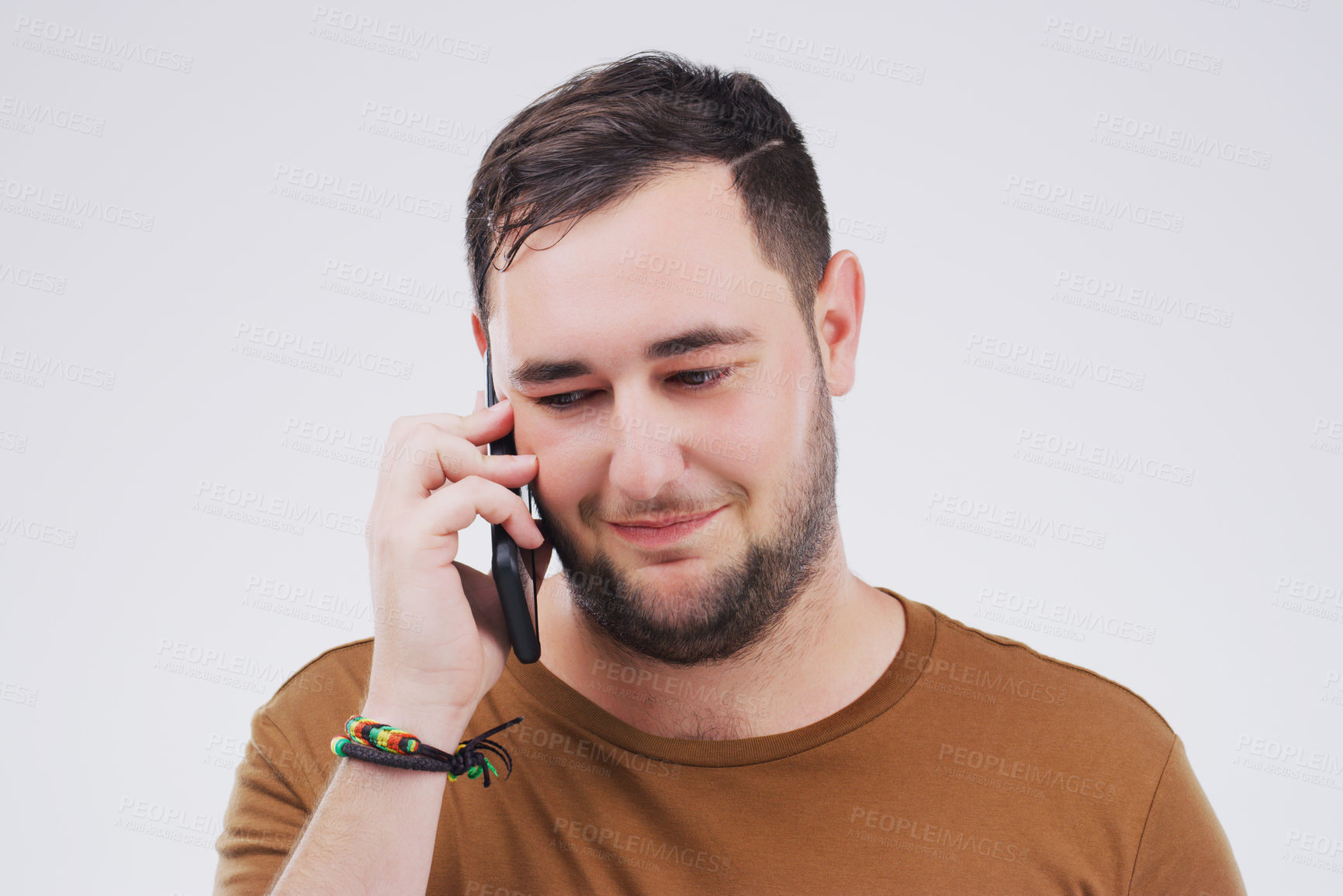 Buy stock photo Chat, phone call and man listening in studio isolated on a white background. Calling, cellphone and male person talking, discussion or speaking, conversation and networking with contact on mobile.
