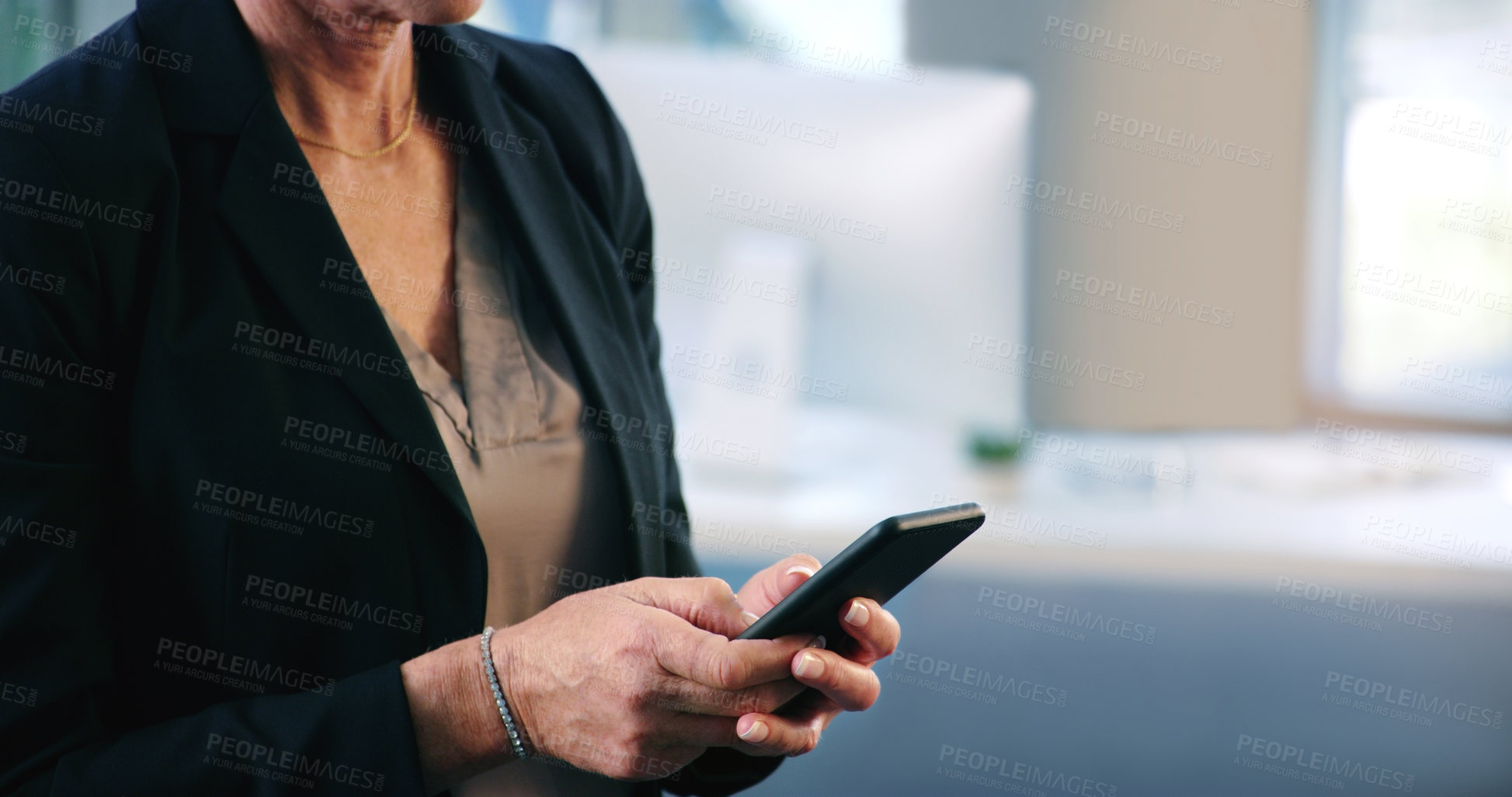 Buy stock photo Closeup shot of a businesswoman texting on a cellphone in an office
