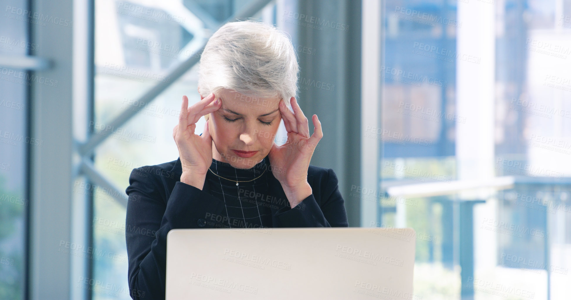 Buy stock photo Shot of a mature businesswoman looking stressed out while working in an office