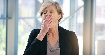 Buy stock photo Shot of a mature businesswoman yawning in an office