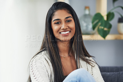 Buy stock photo Cropped portrait of an attractive young woman relaxing on the couch at home