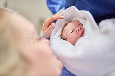Buy stock photo Shot of an adorable baby girl sleeping in her mother's arms in hospital