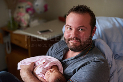 Buy stock photo Portrait of a happy father holding his newborn baby girl in the hospital