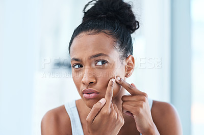 Buy stock photo Cropped shot of a beautiful young woman squeezing a pimple in the mirror