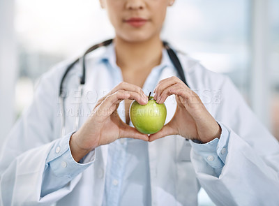 Buy stock photo Closeup shot of an unidentifiable doctor holding an apple