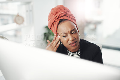 Buy stock photo Cropped shot of an attractive young businesswoman suffering with a headache while sitting at her desk in the office