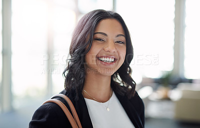 Buy stock photo Cropped portrait of an attractive young businesswoman smiling while standing in a modern office