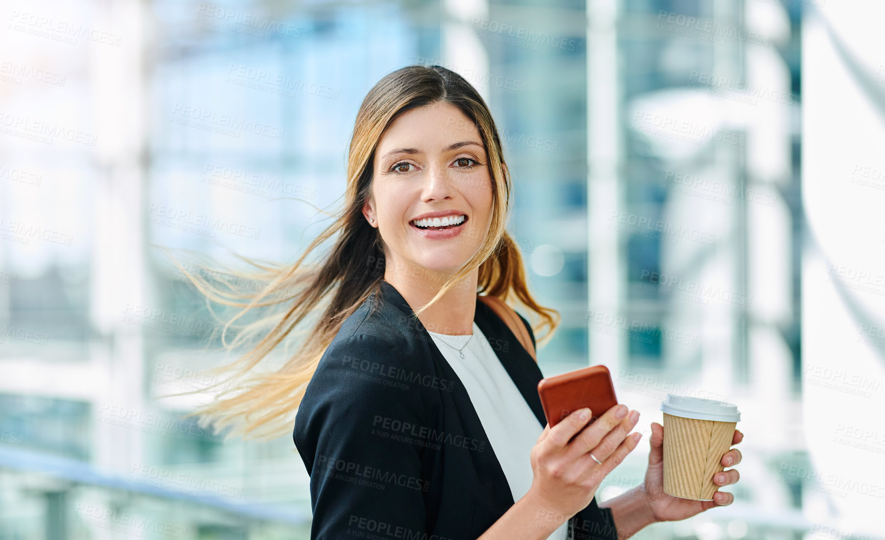 Buy stock photo Cropped portrait of an attractive young businesswoman smiling while walking through a modern office