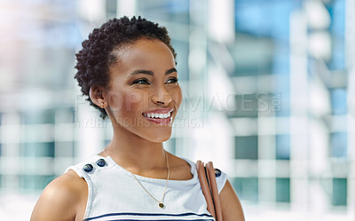Buy stock photo Cropped shot of an attractive young businesswoman smiling thoughtfully while standing in a modern office