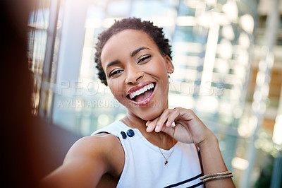 Buy stock photo Cropped portrait of an attractive young businesswoman taking a selfie in a modern workplace