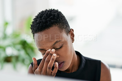 Buy stock photo Shot of a young businesswoman experiencing stress at work