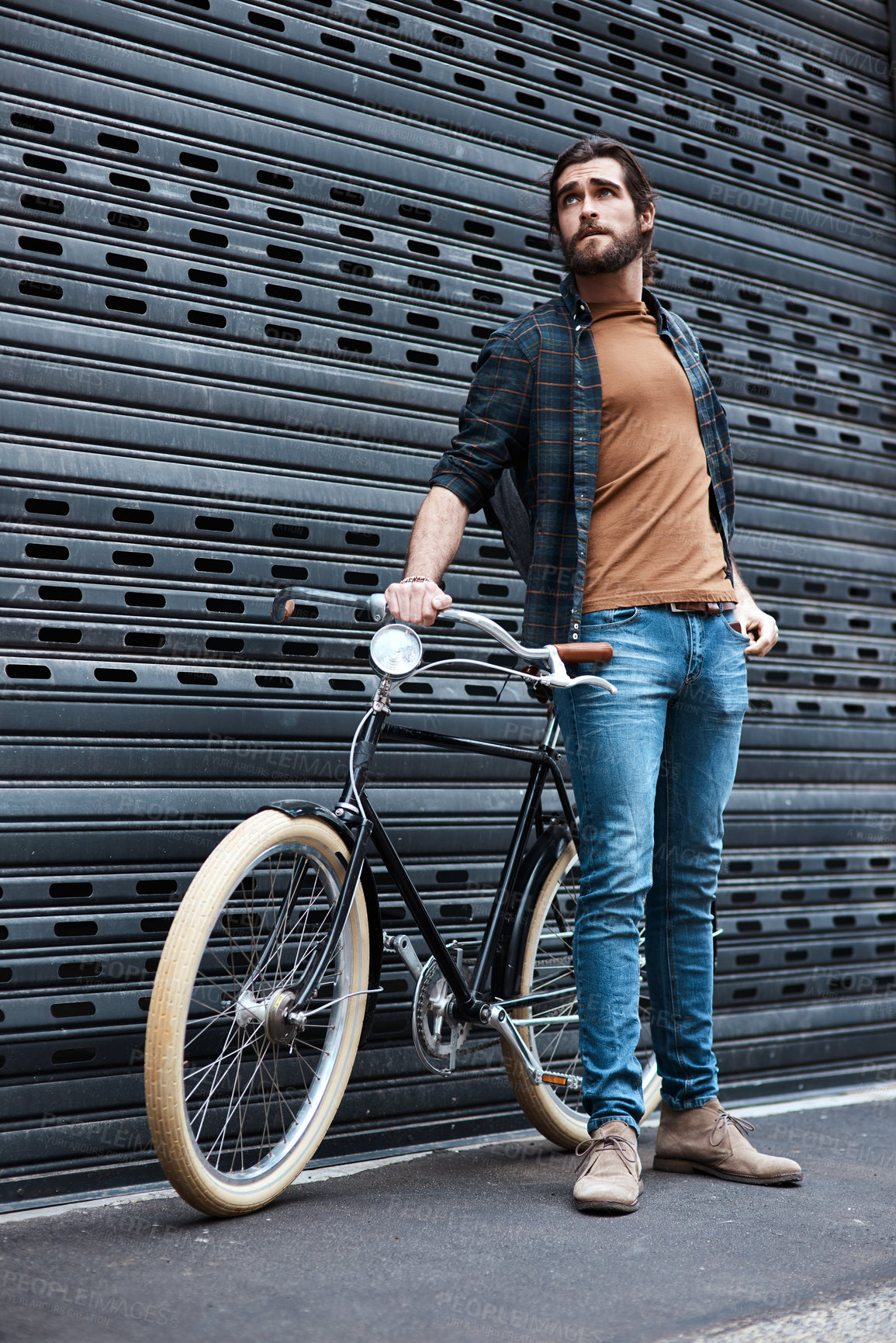 Buy stock photo Full length shot of a handsome young man posing next to his bicycle outdoors