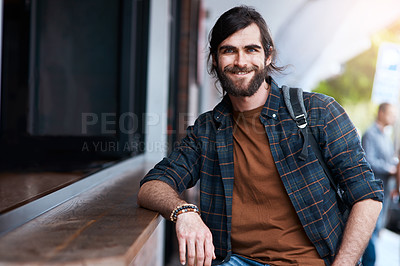 Buy stock photo Portrait of a handsome young man posing outside a cafe in the city