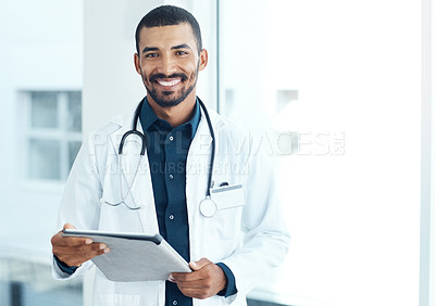 Buy stock photo Portrait of a young doctor using a digital tablet in a modern hospital