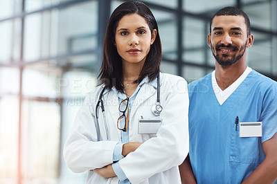 Buy stock photo Portrait of two confident young doctors working in a modern hospital