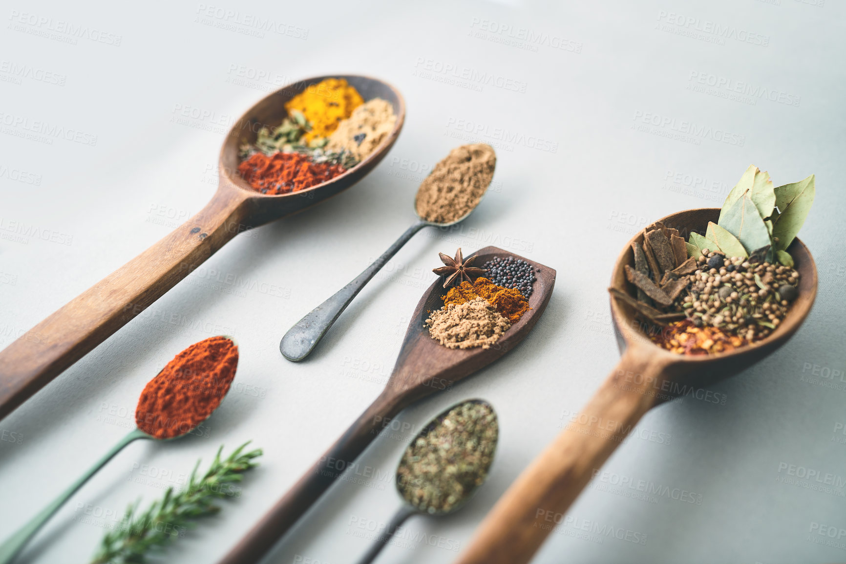 Buy stock photo Spoons, spices or healthy ingredients in studio for recipe, flavor or seasoning in Indian cuisine. Utensils, powder or herbs on white background for spicy meal, cooking preparation or culinary skill