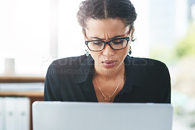 Buy stock photo Shot of a young businesswoman looking stressed out while working in an office