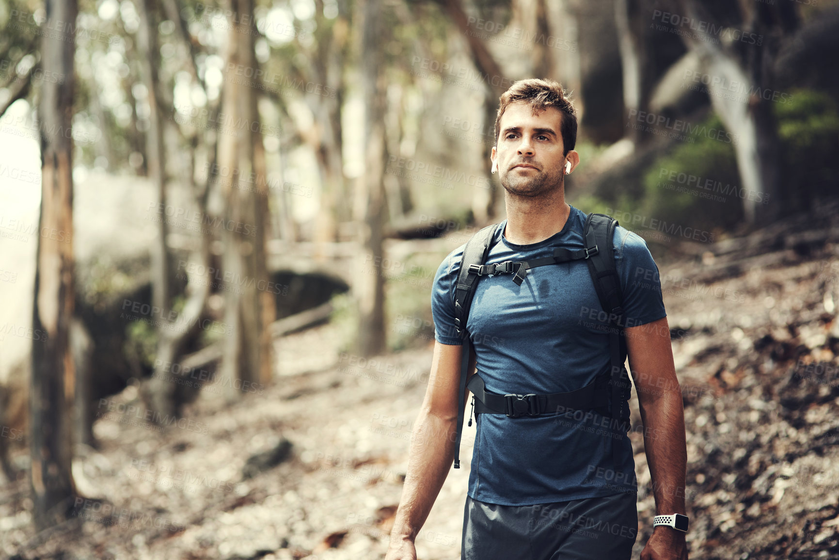 Buy stock photo Cropped shot of a handsome young man out for a hike in the mountains