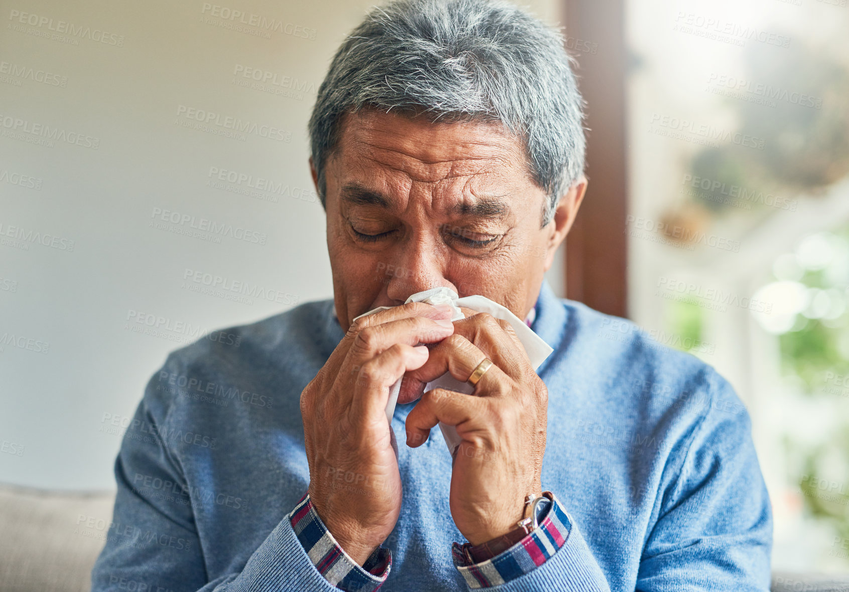 Buy stock photo Senior man, sick and blowing nose in home from virus, allergy and illness on couch. Tired, tissue and elderly male person in a house lounge with sneeze from covid and flu on a sofa with allergies