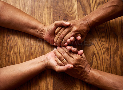 Buy stock photo Closeup, couple and holding hands for comfort, care and empathy or help on table at home. Support, kindness and mature people forgive, love or bonding for connection together with partner for trust