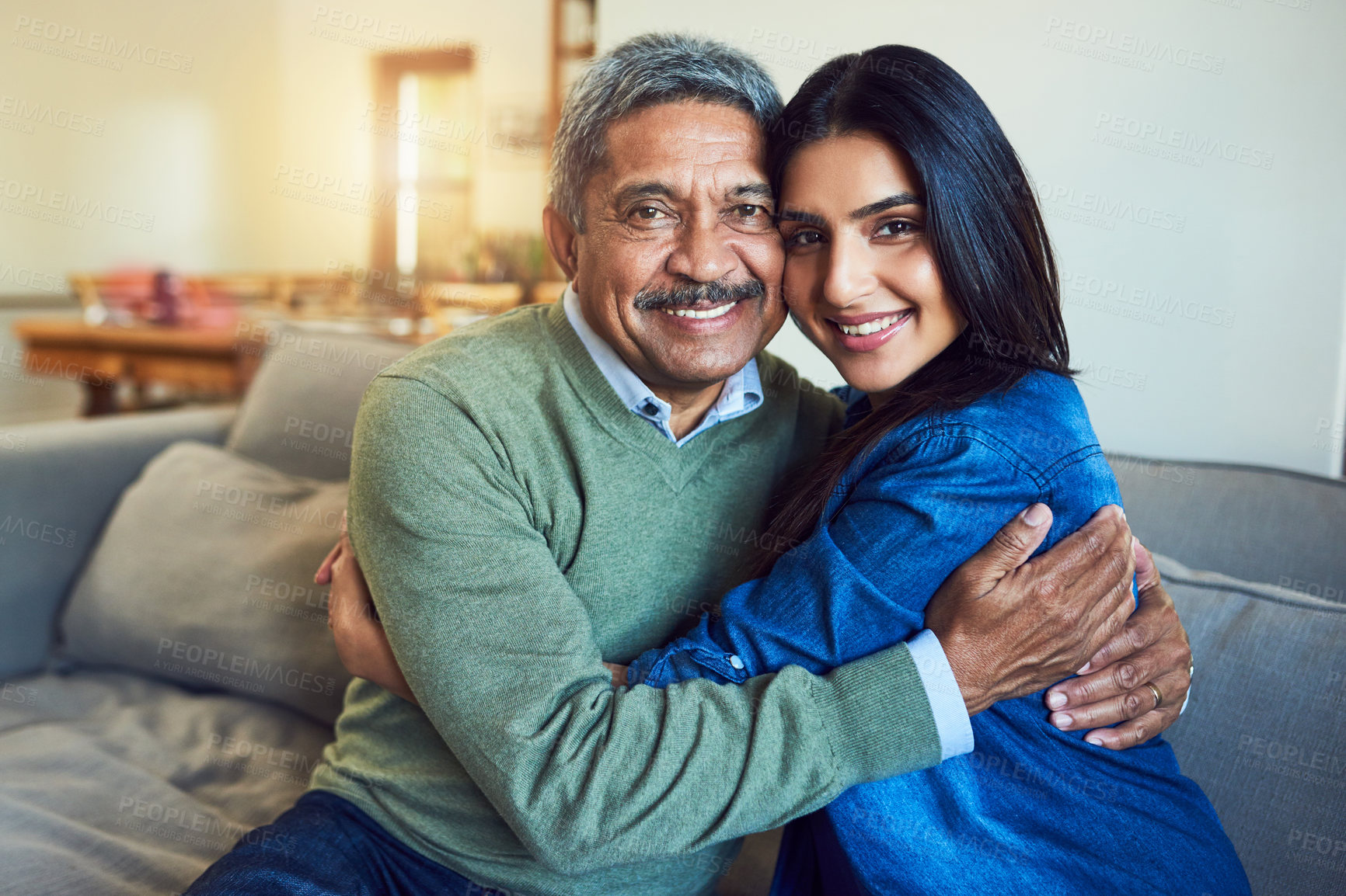 Buy stock photo Portrait of a cheerful senior man posing with his daughter while relaxing on a couch at home