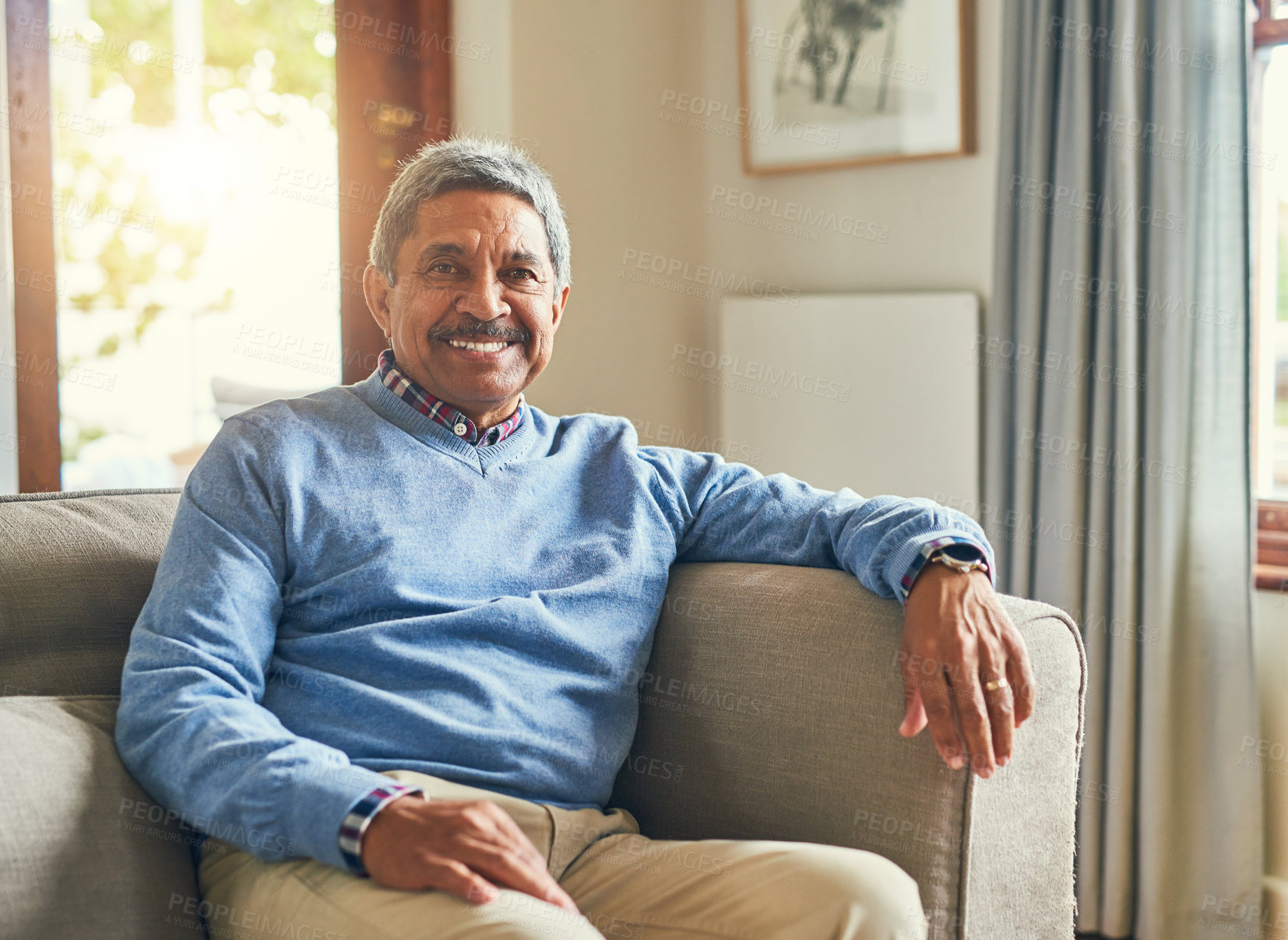 Buy stock photo Portrait of a handsome senior man relaxing on a sofa at home