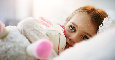 Buy stock photo Shot of an adorable little girl lying in bed with her teddybear at home