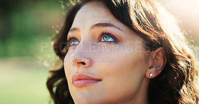 Buy stock photo Closeup shot of an attractive young woman feeling optimistic in a public park