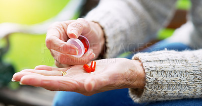 Buy stock photo Person, hand and pill bottle for healthcare tablet or life extension drugs, anti aging or medication. Fingers, outdoor and park with multivitamin or iron supplements for anemia, prescription or pain