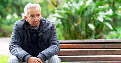 Buy stock photo Cropped shot of a carefree elderly man seated on a bench while contemplating outside in a park