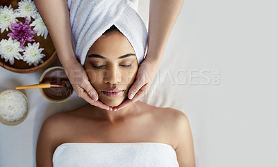 Buy stock photo Shot of a young woman getting a facial treatment at a spa