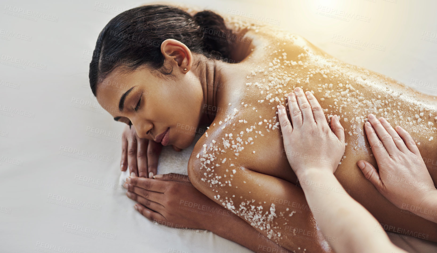 Buy stock photo Shot of a young woman getting an exfoliating massage at a spa
