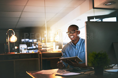 Buy stock photo Cropped shot of a handsome young businessman using a digital tablet during a late night in a modern office
