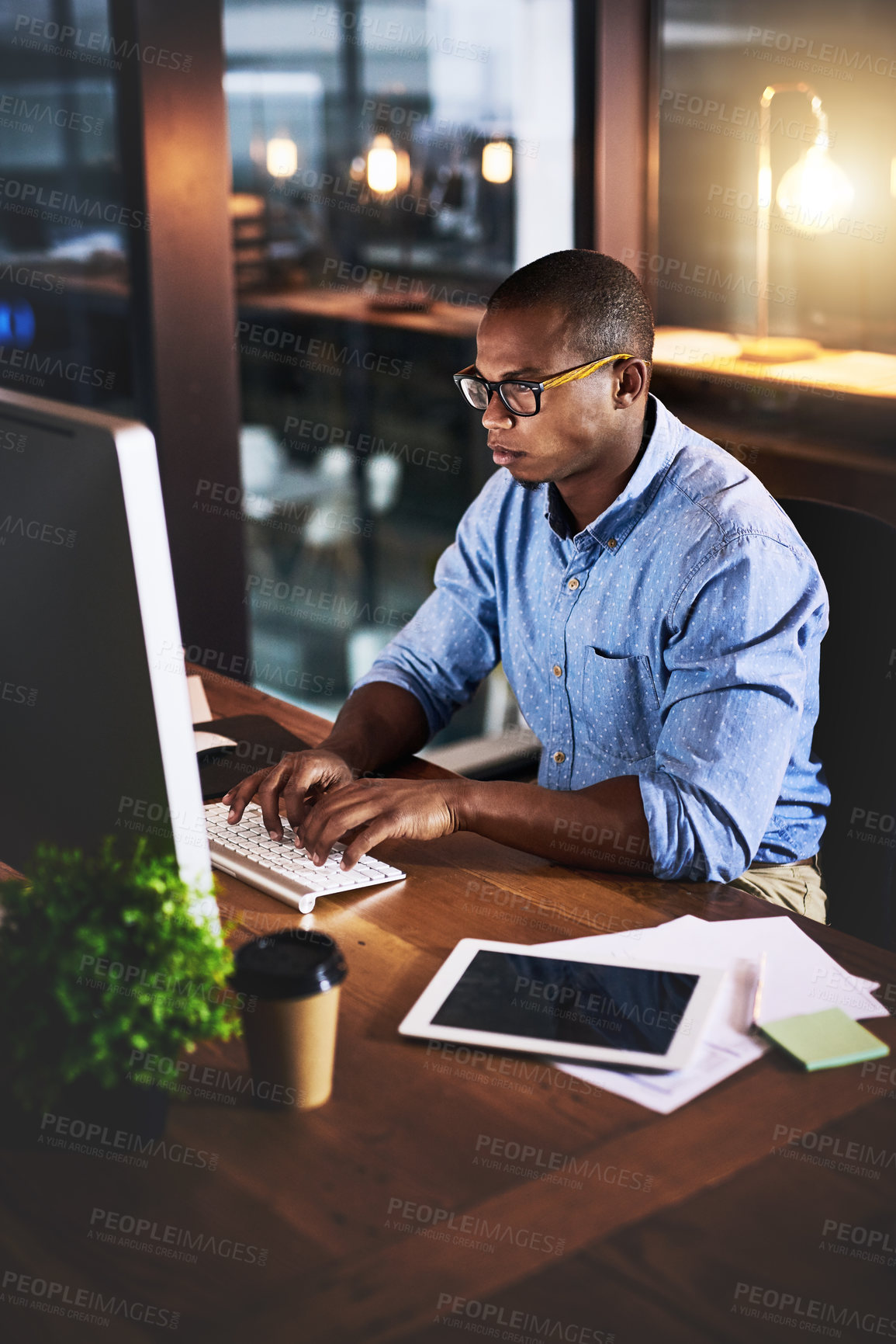 Buy stock photo African, businessman and typing on tech at night in research as corporate communication specialist. Male person, working late and desktop for connection, internet or company as professional in office