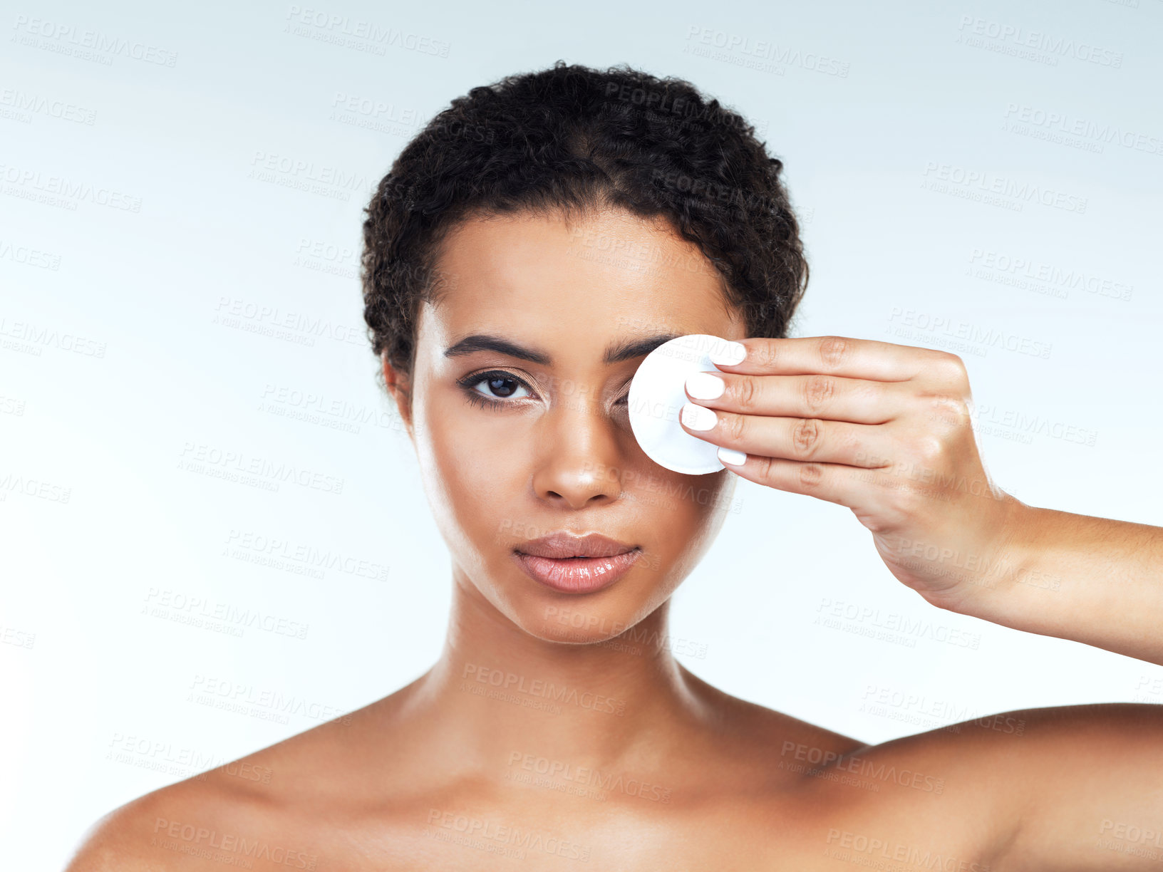Buy stock photo Portrait of an attractive young woman posing while covering her one eye with a cotton pad against a white background
