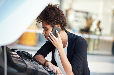 Buy stock photo Cropped shot of an attractive young businesswoman calling roadside assistance after her car broke down