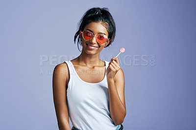 Buy stock photo Girl, portrait and lollipop in studio with sunglasses for fashion, style and trendy happy person. Woman, happiness and candy on background with mockup space or shades for aesthetic, gen z and cool