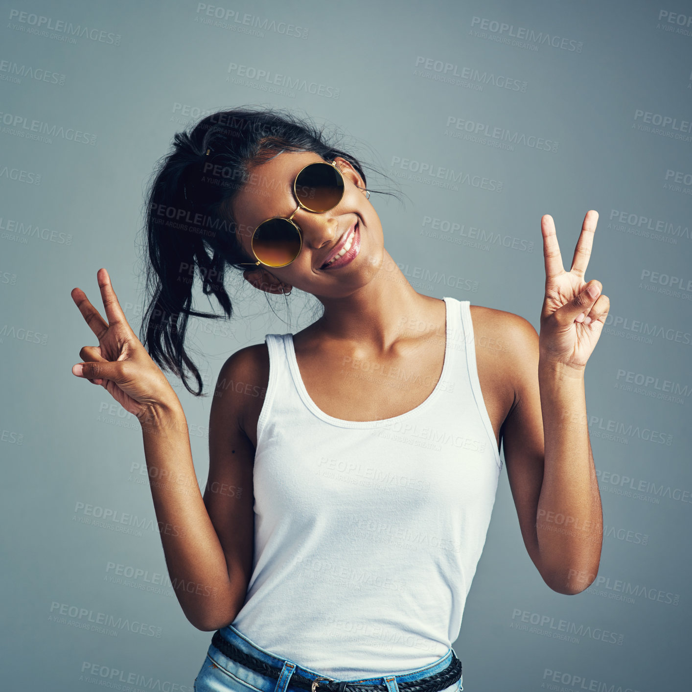 Buy stock photo Studio portrait of a beautiful young woman giving you two peace signs against a grey background