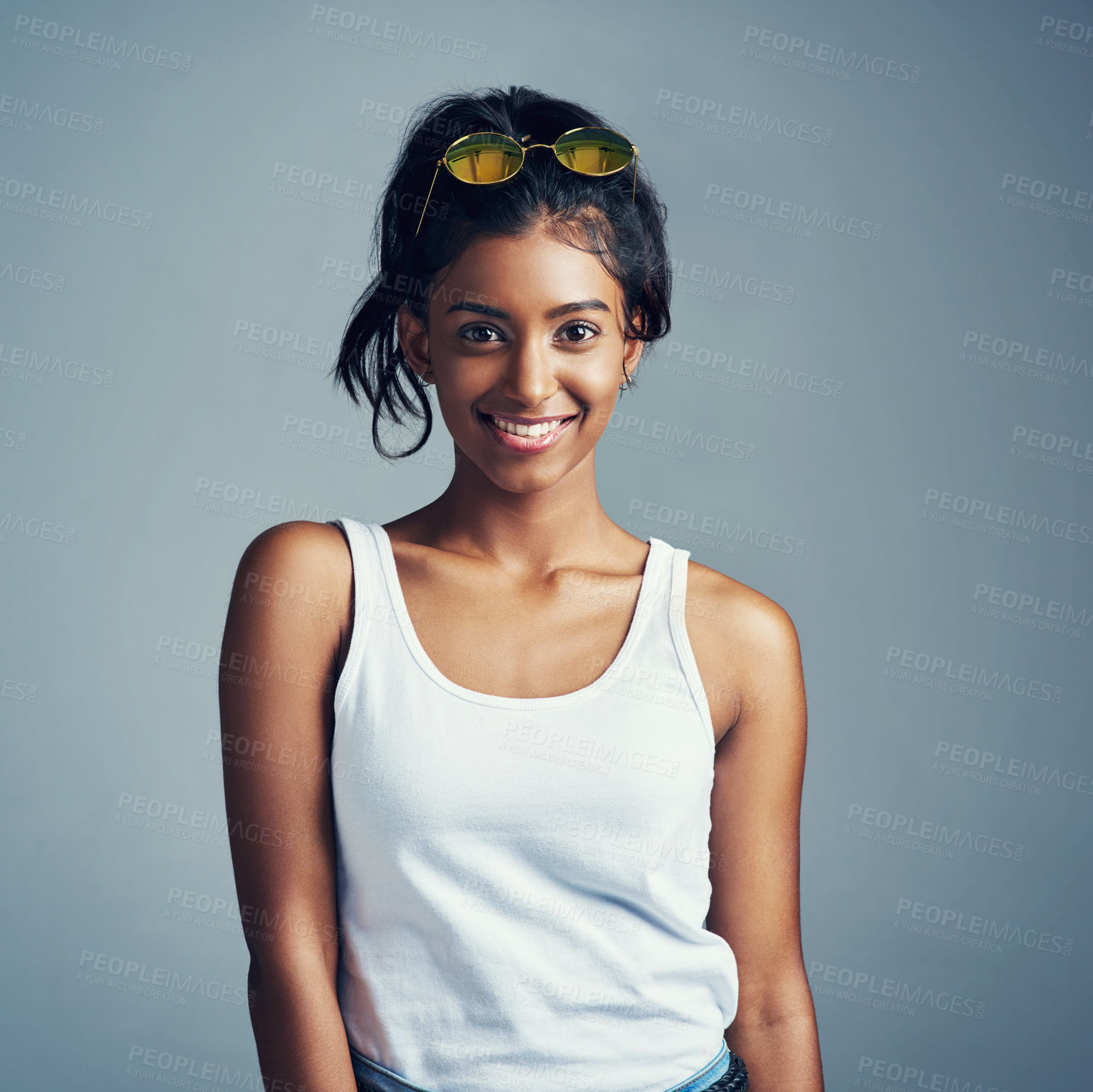 Buy stock photo Studio portrait of a beautiful young woman posing against a grey background