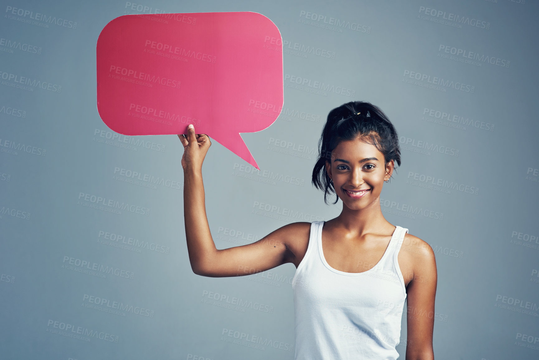 Buy stock photo Studio portrait of a beautiful young woman holding up a blank signboard against a grey background