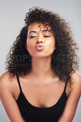 Buy stock photo Studio shot of a beautiful young woman pouting against a grey background