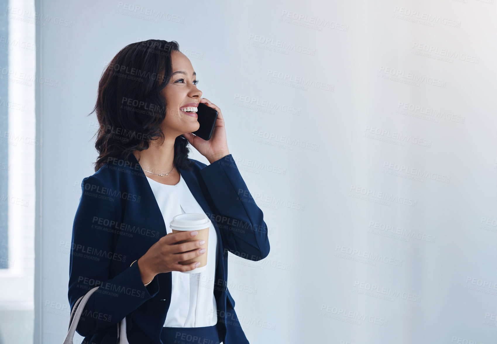 Buy stock photo Shot of a young businesswoman talking on a cellphone in an office