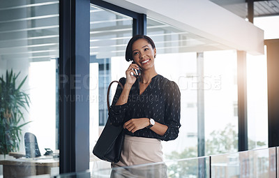 Buy stock photo Shot of a young businesswoman talking on a cellphone in an office