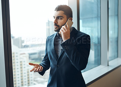 Buy stock photo Shot of a young businessman working in a modern office