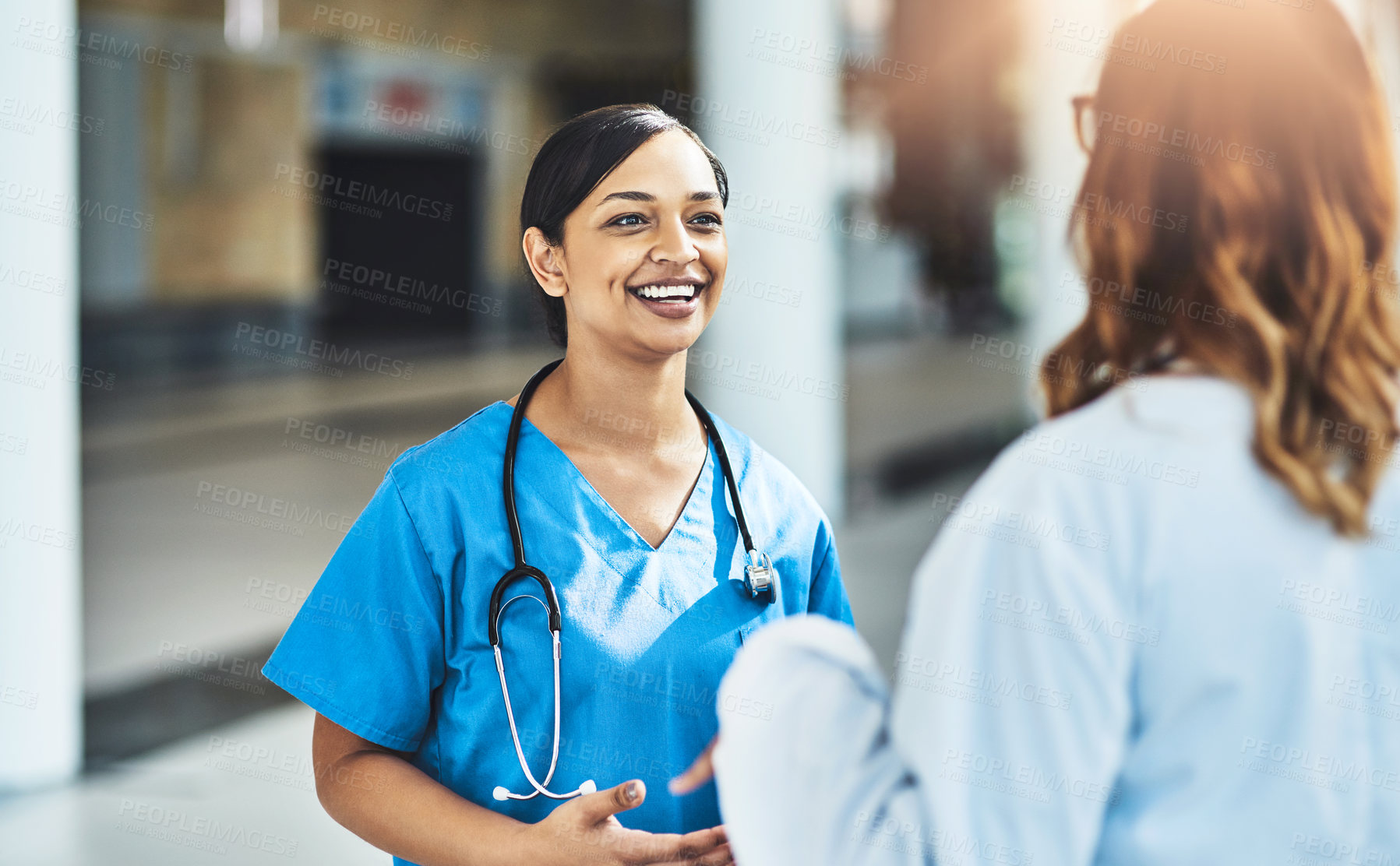 Buy stock photo Cropped shot of two medical practitioners having a discussion in a hospital