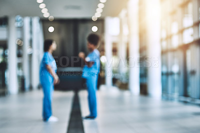 Buy stock photo Shot of two medical practitioners having a discussion in a hospital