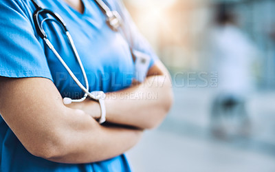 Buy stock photo Cropped shot of a female nurse standing with her arms crossed