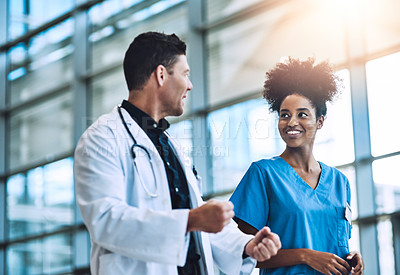 Buy stock photo Shot of medical practitioners having a conversation in a hospital