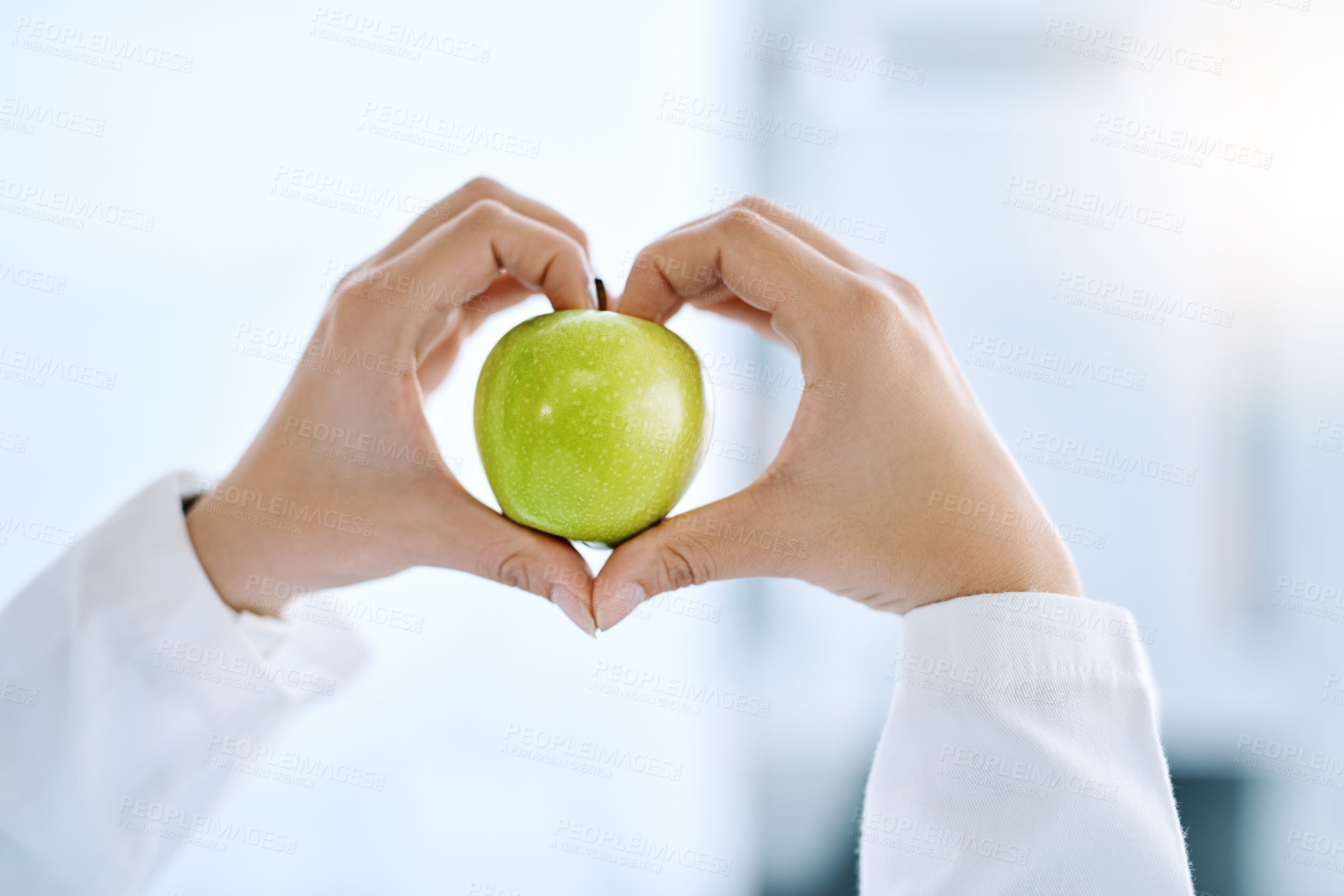 Buy stock photo Closeup shot of an unrecognizable doctor holding an apple